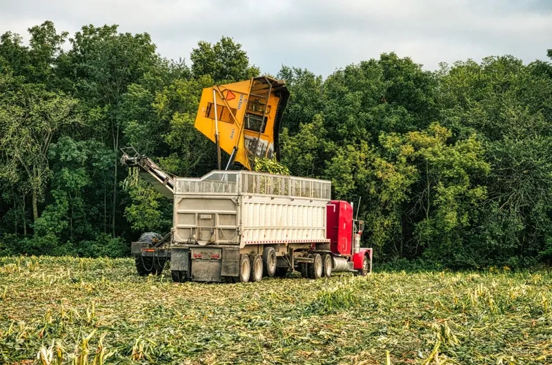 A harvester loading a trailer in a field