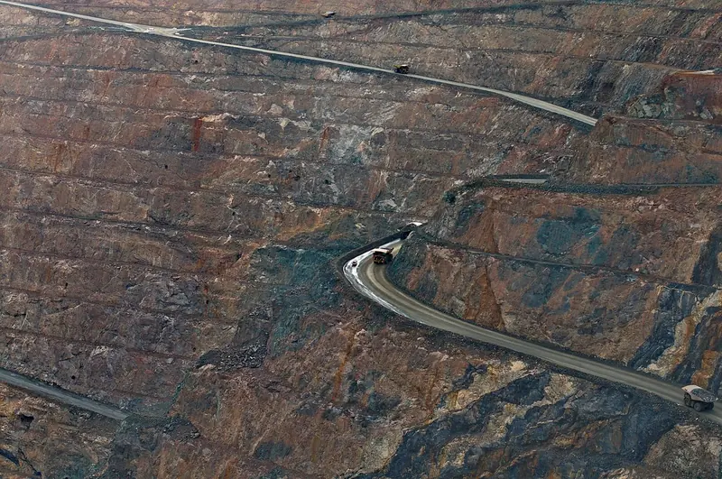 Aerial view of haul trucks on a quarry road